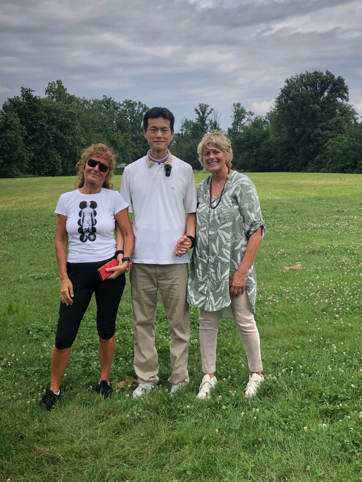 Master Lo with two local Italian students, a keepsake photo on the grass