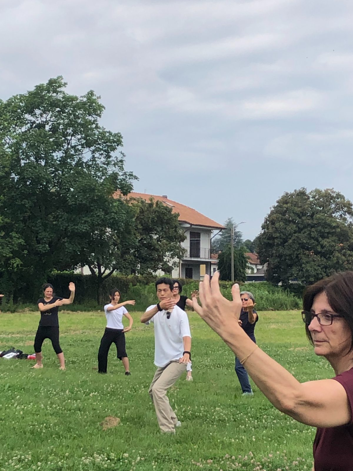 Master Lo leading Italian students through the form together